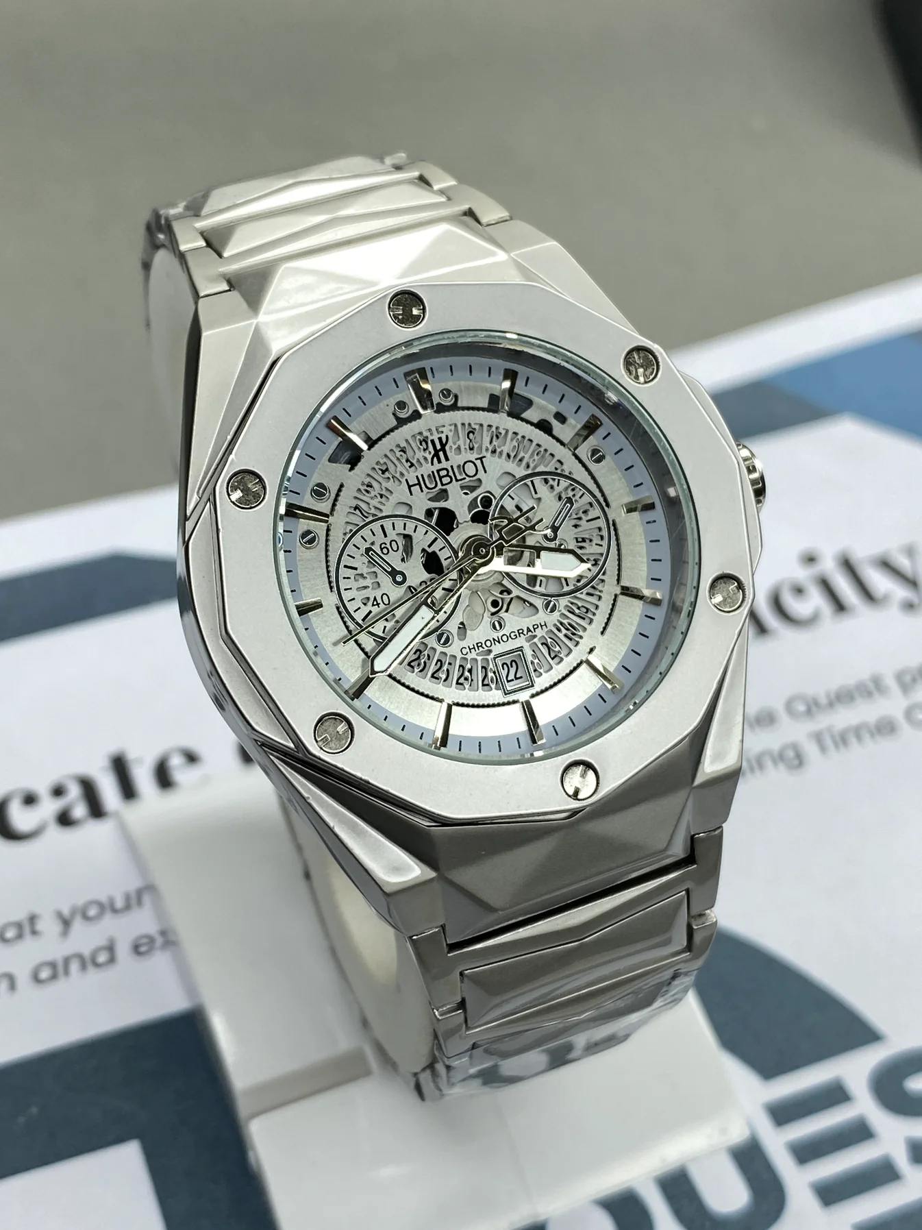 Hublot white chronograph watch with ceramic and stainless steel band, luxury sporty timepiece for men.